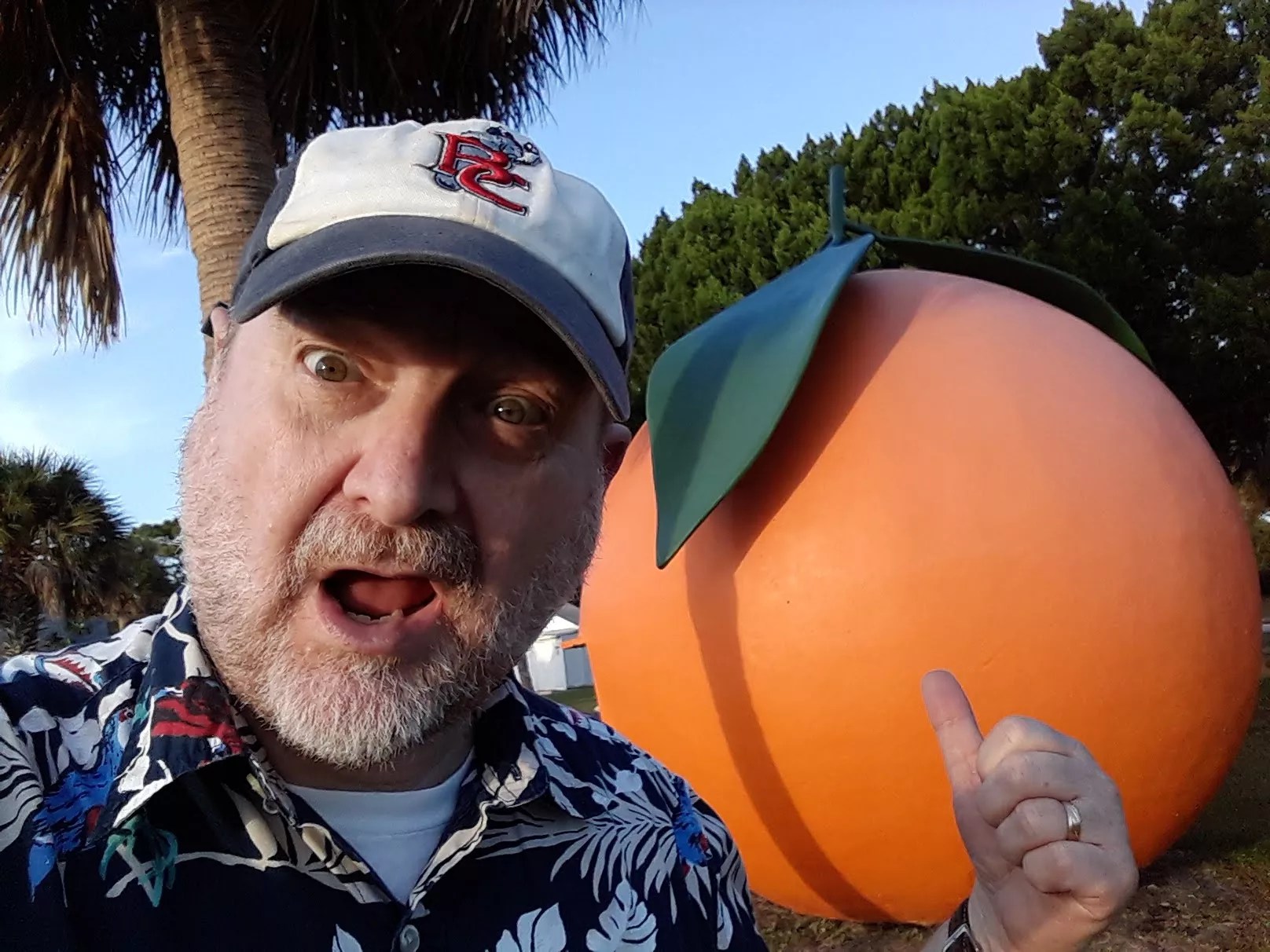 selfie of Craig Pittman in front of a sculpture of an orange